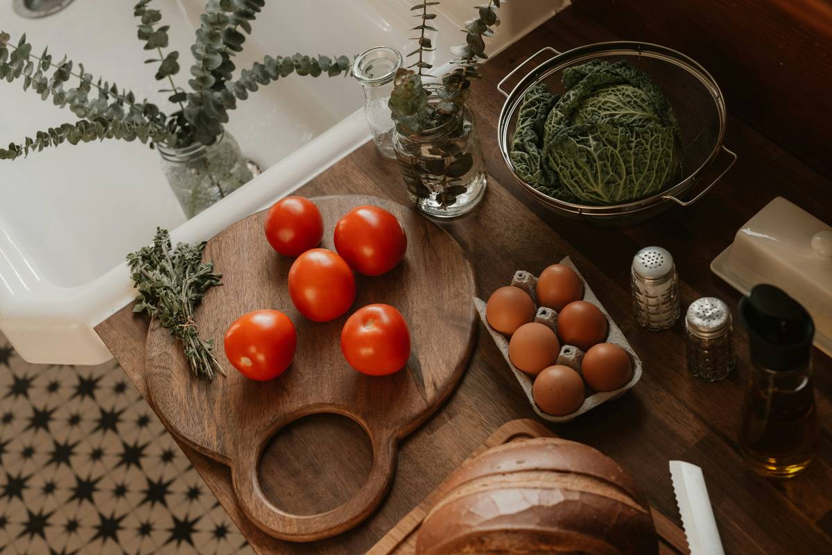 A clean countertop with chopped vegetables, measuring spoons, and a skillet—visual setup for a beginners guide to cooking